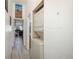 Hallway with stacked washer and dryer and a view of a home office at 532 Oakwood Dr # D202, Castle Rock, CO 80104