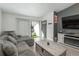 Cozy living room with balcony, gray couch, fireplace, and modern decor at 532 Oakwood Dr # D202, Castle Rock, CO 80104