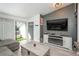 Open living room with modern decor, fireplace, tv, and balcony access at 532 Oakwood Dr # D202, Castle Rock, CO 80104