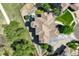 Aerial view of a luxurious home showcasing its unique roof design, landscaping, and surrounding neighborhood at 24031 E Hinsdale Pl, Aurora, CO 80016