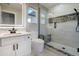 Modern bathroom with shower featuring decorative tilework, a sleek vanity, and a well-lit LED mirror at 24031 E Hinsdale Pl, Aurora, CO 80016