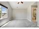 A very nice sized bedroom featuring neutral paint, carpeted floors, ceiling fan, window, and an adjacent bathroom at 24031 E Hinsdale Pl, Aurora, CO 80016