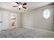 A bedroom featuring neutral colored walls, a ceiling fan, and an arched window at 24031 E Hinsdale Pl, Aurora, CO 80016