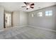 Bedroom featuring a ceiling fan and three windows, offering ample natural light and ventilation at 24031 E Hinsdale Pl, Aurora, CO 80016