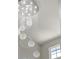 Elegant chandelier hangs from a high ceiling, creating a stunning focal point at 24031 E Hinsdale Pl, Aurora, CO 80016