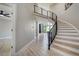 Elegant foyer featuring a curved staircase with modern black railings and light wood steps at 24031 E Hinsdale Pl, Aurora, CO 80016