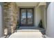 Elegant front doors with decorative metalwork, flanked by stone columns and manicured greenery at 24031 E Hinsdale Pl, Aurora, CO 80016