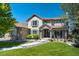Inviting front exterior showcasing a landscaped yard, stone accents, and a welcoming entrance with stone pillars at 24031 E Hinsdale Pl, Aurora, CO 80016