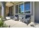 Inviting front porch featuring comfortable seating, decorative columns, and stylish doors at 24031 E Hinsdale Pl, Aurora, CO 80016