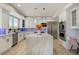 Bright and modern kitchen with white cabinets, stainless steel appliances and an island with seating at 24031 E Hinsdale Pl, Aurora, CO 80016