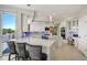 Modern kitchen featuring white cabinets, a large island, stainless steel appliances, and bar stool seating at 24031 E Hinsdale Pl, Aurora, CO 80016