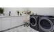 Well-equipped laundry room featuring side by side washer and dryer and storage cabinets at 24031 E Hinsdale Pl, Aurora, CO 80016
