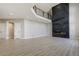 Open concept living room featuring a stone fireplace, soaring ceilings, and plenty of space at 24031 E Hinsdale Pl, Aurora, CO 80016