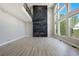 Spacious living room features a modern fireplace, soaring ceilings, and ample natural light at 24031 E Hinsdale Pl, Aurora, CO 80016