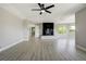 Spacious living room features a fireplace, ceiling fan, and hardwood floors at 24031 E Hinsdale Pl, Aurora, CO 80016