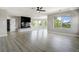 Spacious living area featuring a fireplace, modern lighting, and scenic windows at 24031 E Hinsdale Pl, Aurora, CO 80016