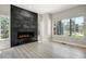 Bright living room featuring a modern fireplace with a black stone surround and large windows at 24031 E Hinsdale Pl, Aurora, CO 80016