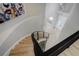 Dramatic staircase featuring curved design, metal railings, and a view of the entryway at 24031 E Hinsdale Pl, Aurora, CO 80016