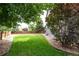 Well-maintained backyard featuring lush green grass, manicured landscaping, and a wooden privacy fence at 14962 Williams St, Thornton, CO 80602