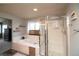 Bright bathroom featuring a soaking tub and glass-enclosed shower at 14962 Williams St, Thornton, CO 80602