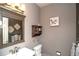 Cozy powder room features stylish wall decor, framed mirror, and vanity sink at 14962 Williams St, Thornton, CO 80602