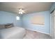 Comfortable bedroom featuring blue walls, carpet flooring, and a ceiling fan at 14962 Williams St, Thornton, CO 80602