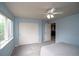 Bright bedroom featuring blue walls, large closet, and natural light at 14962 Williams St, Thornton, CO 80602