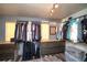 Walk-in closet with custom shelving, drawers, and ample storage space for clothing and accessories at 14962 Williams St, Thornton, CO 80602