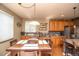 A dining room table sits near the kitchen, which has a breakfast bar with barstools at 14962 Williams St, Thornton, CO 80602