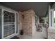 Inviting front porch with brick accents, decorative plants, and seating area at 14962 Williams St, Thornton, CO 80602