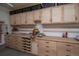 Organized garage workshop with custom wood cabinets and drawers for ample storage at 14962 Williams St, Thornton, CO 80602