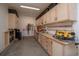 Spacious garage with ample lighting, custom cabinets, and workbench area, perfect for storage and projects at 14962 Williams St, Thornton, CO 80602
