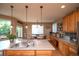 A sunny kitchen boasts a spacious island with a sink and room for barstool seating at 14962 Williams St, Thornton, CO 80602
