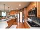Modern kitchen with stainless steel appliances, hardwood floors, and breakfast bar at 14962 Williams St, Thornton, CO 80602