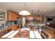 Open concept kitchen with wood cabinets, stainless appliances, and a large island with seating at 14962 Williams St, Thornton, CO 80602