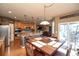 Open concept kitchen and dining area with stainless appliances, hardwood floors at 14962 Williams St, Thornton, CO 80602