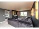 Comfortable living room with an electric fireplace, mounted TV, and a cozy gray sofa set at 14962 Williams St, Thornton, CO 80602