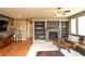 Cozy living room with a stone fireplace, built-in shelving, and warm, inviting decor at 14962 Williams St, Thornton, CO 80602
