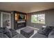 Comfortable living room with an electric fireplace, mounted TV, and a cozy gray sofa set at 14962 Williams St, Thornton, CO 80602