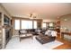An open-concept living room leads to a spacious kitchen and dining area; hardwood flooring at 14962 Williams St, Thornton, CO 80602