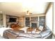 Spacious living room featuring a wood-paneled accent wall, fireplace, and comfortable seating at 14962 Williams St, Thornton, CO 80602