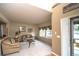 Cozy living room with neutral carpet, large windows, and comfortable seating at 14962 Williams St, Thornton, CO 80602