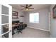 This office space includes a ceiling fan, shelves, desk with drawers, and dual monitors for optimal work from home setup at 14962 Williams St, Thornton, CO 80602