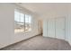 Bright bedroom with a large window and closet with sliding doors at 2056 S Haleyville Way, Aurora, CO 80018