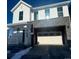 Two-story farmhouse-style home with white siding, gray stone accents, and a two-car garage at 2056 S Haleyville Way, Aurora, CO 80018