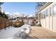 Side yard with gate access, snow, and mature landscaping at 2550 W 43Rd Ave, Denver, CO 80211