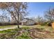 Large backyard with mature trees and wood fence at 4780 Pennsylvania St, Denver, CO 80216