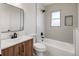 Modern bathroom with a tiled shower, stylish vanity, and contemporary fixtures and neutral toned tile at 4780 Pennsylvania St, Denver, CO 80216