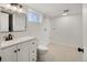 Bright bathroom with white vanity, black hardware, and tile flooring at 4780 Pennsylvania St, Denver, CO 80216