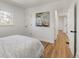 Bedroom featuring hardwood floors and neutral walls with a view to the hallway and closet at 4780 Pennsylvania St, Denver, CO 80216